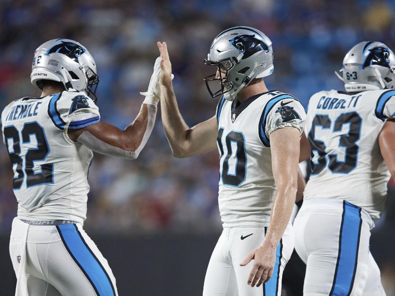 Carolina Panthers punter Johnny Hekker (10) high fives teammate tight end Tommy Tremble (82) following an extra point during an NFL preseason football game against the Buffalo Bills, Saturday, Aug. 26, 2022, in Charlotte, N.C. (AP Photo/Brian Westerholt)