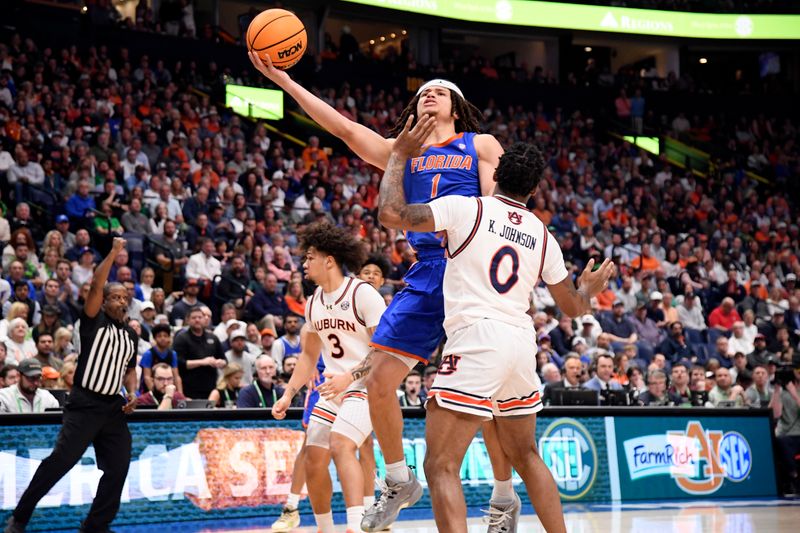 Mar 17, 2024; Nashville, TN, USA; Florida Gators guard Walter Clayton Jr. (1) shoots against Auburn Tigers guard K.D. Johnson (0) in the first half in the SEC Tournament championship game at Bridgestone Arena. Mandatory Credit: Steve Roberts-USA TODAY Sports