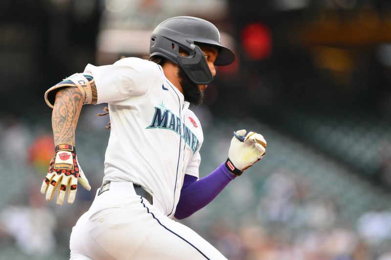 May 27, 2024; Seattle, Washington, USA; Seattle Mariners shortstop J.P. Crawford (3) runs towards first base after hitting a double against the Houston Astros during the first inning at T-Mobile Park. Mandatory Credit: Steven Bisig-USA TODAY Sports