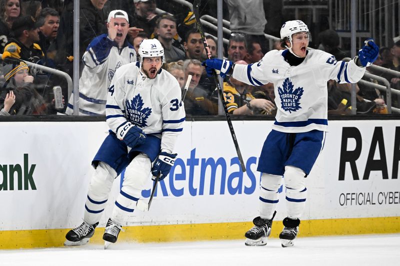 Apr 22, 2024; Boston, Massachusetts, USA; Toronto Maple Leafs center Auston Matthews (34) reacts with left wing Tyler Bertuzzi (59) after scoring a goal against the Boston Bruins during the third period in game two of the first round of the 2024 Stanley Cup Playoffs at TD Garden. Mandatory Credit: Brian Fluharty-USA TODAY Sports