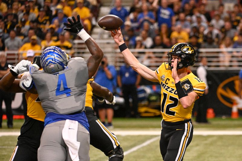 Sep 23, 2023; St. Louis, Missouri, USA; Memphis Tigers defensive lineman Josh Ellison (4) attempts to block a pass from Missouri Tigers quarterback Brady Cook (12) in the first quarter at The Dome at America's Center. Mandatory Credit: Joe Puetz-USA TODAY Sports