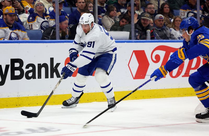 Mar 14, 2026; Buffalo, New York, USA;  Toronto Maple Leafs center John Tavares (91) looks to make a pass as Buffalo Sabres defenseman Owen Power (25) defends during the third period at KeyBank Center. Mandatory Credit: Timothy T. Ludwig-Imagn Images