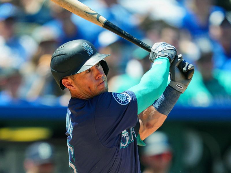 Jun 9, 2024; Kansas City, Missouri, USA; Seattle Mariners third baseman Dylan Moore (25) hits a single during the sixth inning against the Kansas City Royals at Kauffman Stadium. Mandatory Credit: Jay Biggerstaff-USA TODAY Sports