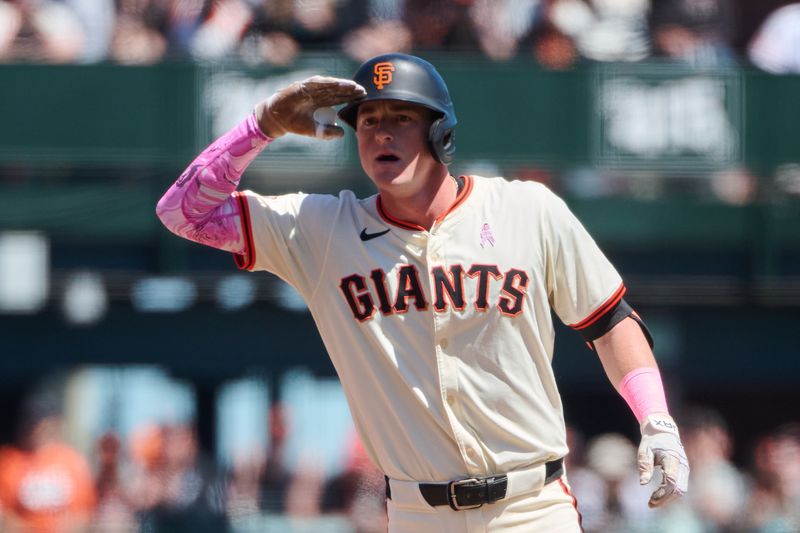 May 12, 2024; San Francisco, California, USA; San Francisco Giants infielder Tyler Fitzgerald (49) salutes the Giants dugout after hitting a double against the Cincinnati Reds during the fifth inning at Oracle Park. Mandatory Credit: Robert Edwards-USA TODAY Sports