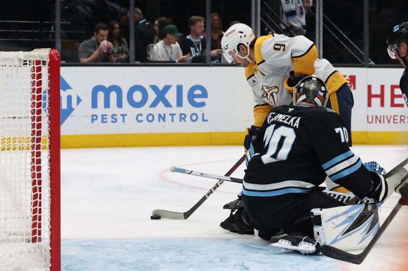 Apr 10, 2025; Salt Lake City, Utah, USA; Nashville Predators left wing Filip Forsberg (9) shoots around Utah Hockey Club goaltender Karel Vejmelka (70) for a goal during the third period at Delta Center. Mandatory Credit: Rob Gray-Imagn Images
