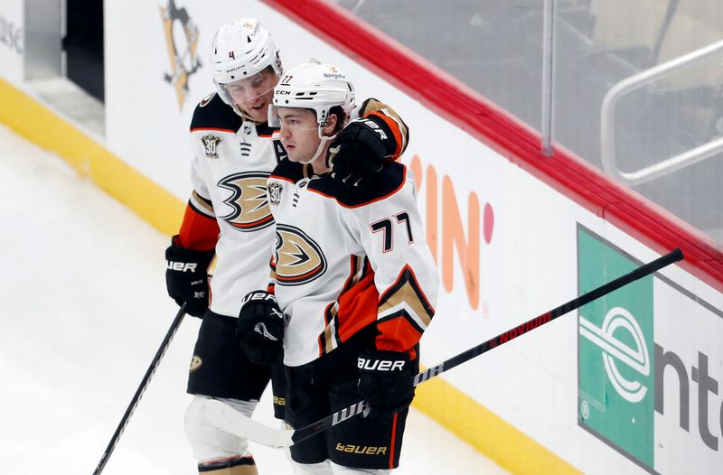 Oct 30, 2023; Pittsburgh, Pennsylvania, USA;  Anaheim Ducks defenseman Cam Fowler (4) congratulates right wing Frank Vatrano (77) on his power play goal against the Pittsburgh Penguins during the second period at PPG Paints Arena. Mandatory Credit: Charles LeClaire-USA TODAY Sports