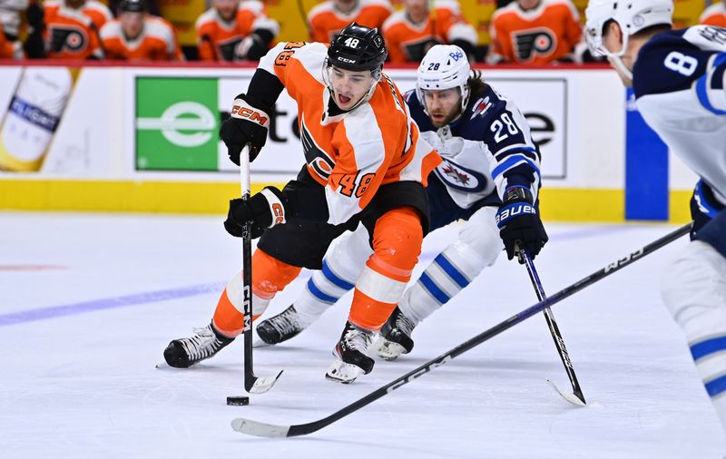 Jan 22, 2023; Philadelphia, Pennsylvania, USA; Philadelphia Flyers center Morgan Frost (48) reaches for the puck against Winnipeg Jets center Kevin Stenlund (28) in the second period at Wells Fargo Center. Mandatory Credit: Kyle Ross-USA TODAY Sports