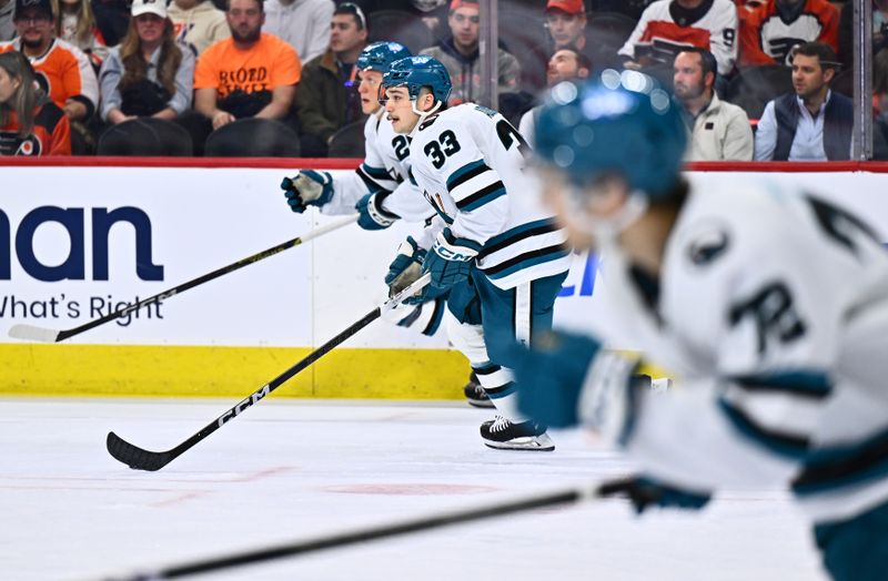 Mar 12, 2024; Philadelphia, Pennsylvania, USA; San Jose Sharks defenseman Calen Addison (33) controls the puck against the Philadelphia Flyers in the first period at Wells Fargo Center. Mandatory Credit: Kyle Ross-USA TODAY Sports