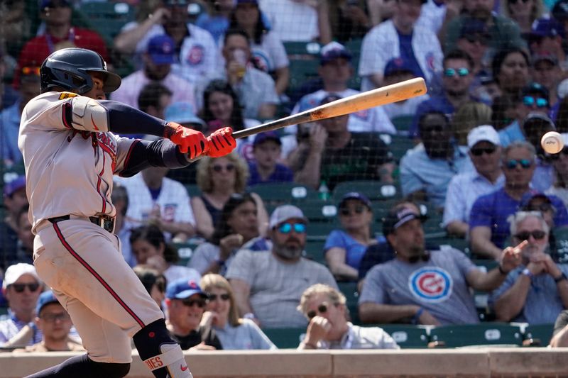 May 23, 2024; Chicago, Illinois, USA; Atlanta Braves second base Ozzie Albies (1) hits a one run single against the Chicago Cubs during the eighth inning at Wrigley Field. Mandatory Credit: David Banks-USA TODAY Sports