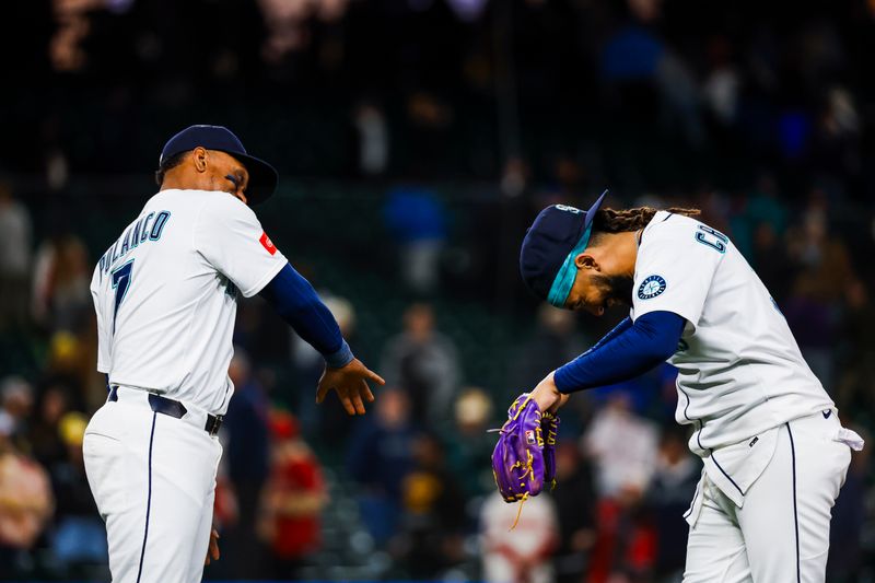 Apr 29, 2025; Seattle, Washington, USA; Seattle Mariners designated hitter Jorge Polanco (7) celebrates with shortstop J.P. Crawford (3) following a 5-3 victory against the Los Angeles Angels at T-Mobile Park. Mandatory Credit: Joe Nicholson-Imagn Images