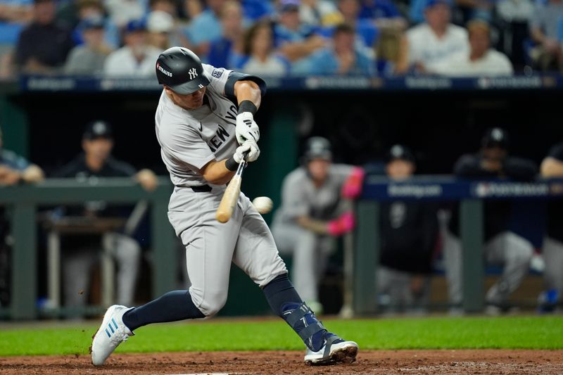 Oct 9, 2024; Kansas City, Missouri, USA; New York Yankees shortstop Anthony Volpe (11) hits a single in the fifth inning against the Kansas City Royals during game three of the NLDS for the 2024 MLB Playoffs at Kauffman Stadium. Mandatory Credit: Jay Biggerstaff -Imagn Images