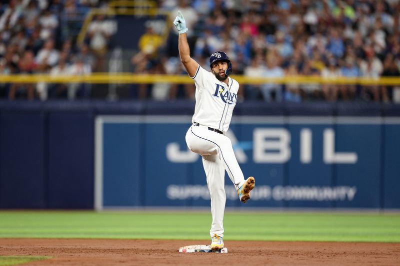 Jul 11, 2024; St. Petersburg, Florida, USA; Tampa Bay Rays second baseman Amed Rosario (10) reacts after hitting an rbi double against the New York Yankees in the second inning  at Tropicana Field. Mandatory Credit: Nathan Ray Seebeck-USA TODAY Sports