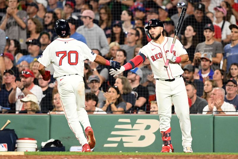 Aug 27, 2024; Boston, Massachusetts, USA; Boston Red Sox shortstop David Hamilton (70) high-fives right fielder Wilyer Abreu (52) after scoring a run against the Toronto Blue Jays during the fifth inning at Fenway Park. Mandatory Credit: Brian Fluharty-USA TODAY Sports