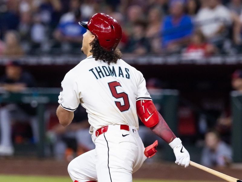 Aug 19, 2025; Phoenix, Arizona, USA; Arizona Diamondbacks outfielder Alek Thomas hits a fifth inning triple against the Cleveland Guardians at Chase Field. Mandatory Credit: Mark J. Rebilas-Imagn Images