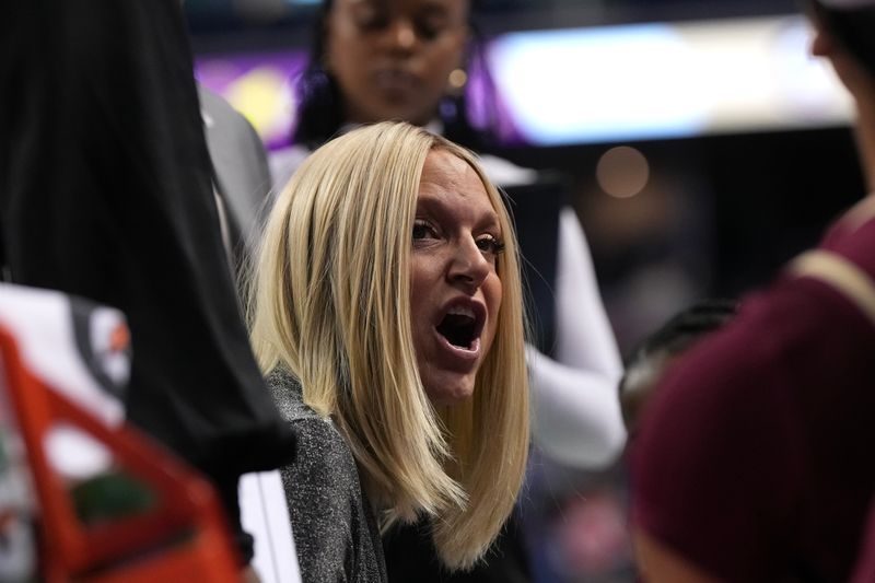 Mar 9, 2024; Greensboro, NC, USA; Florida State Seminoles head coach Brooke Wyckoff talks with her team during a timeout in the second half at Greensboro Coliseum. Mandatory Credit: David Yeazell-USA TODAY Sports