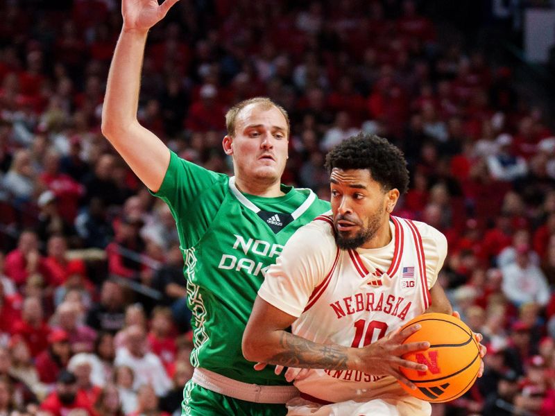 Dec 21, 2025; Lincoln, Nebraska, USA; Nebraska Cornhuskers guard Jamarques Lawrence (10) drives against North Dakota Fighting Hawks guard Eli King (2) during the first half at Pinnacle Bank Arena. Mandatory Credit: Dylan Widger-Imagn Images
