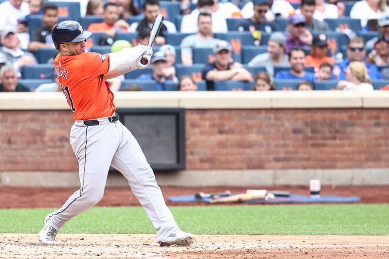 Jun 30, 2024; New York City, New York, USA;  Houston Astros catcher Yainer Diaz (21) hits an RBI single in the fourth inning against the New York Mets at Citi Field. Mandatory Credit: Wendell Cruz-USA TODAY Sports