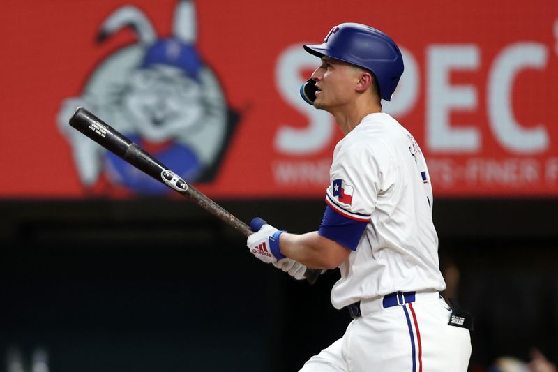 Aug 19, 2024; Arlington, Texas, USA; Texas Rangers shortstop Corey Seager (5) hits a home run against the Pittsburgh Pirates in the first inning at Globe Life Field. Mandatory Credit: Tim Heitman-USA TODAY Sports