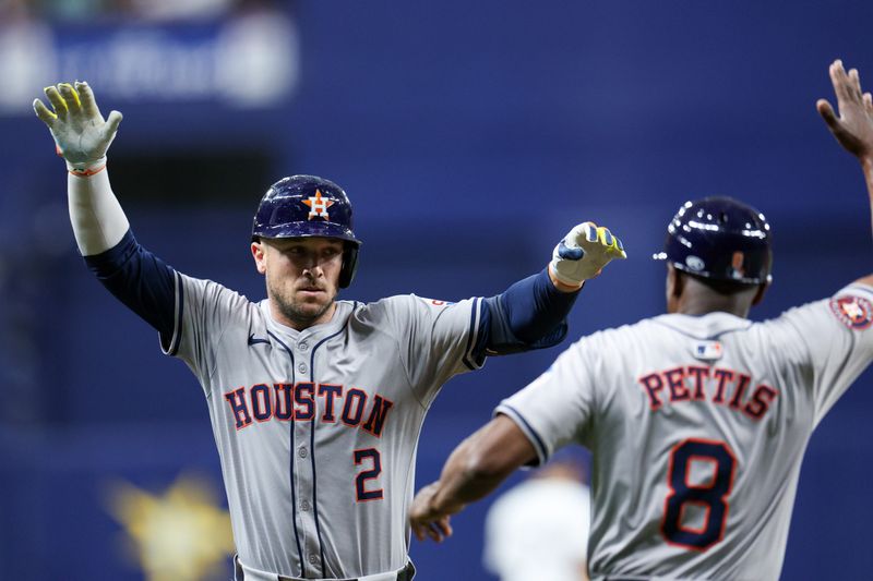 Aug 13, 2024; St. Petersburg, Florida, USA; Houston Astros third baseman Alex Bregman (2) is congratulated by third base coach Gary Pettis (8) after hitting a home run against the Tampa Bay Rays in the fifth inning at Tropicana Field. Mandatory Credit: Nathan Ray Seebeck-USA TODAY Sports