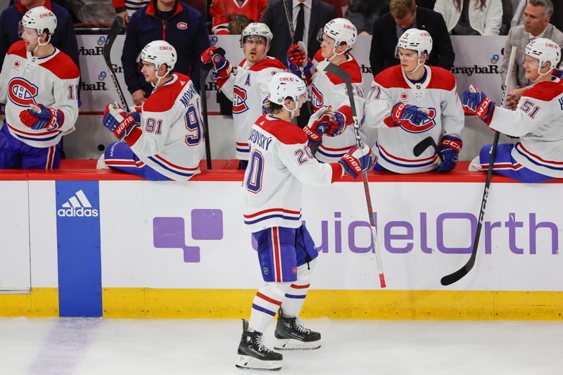 Dec 22, 2023; Chicago, Illinois, USA; Montreal Canadiens left wing Juraj Slafkovsky (20) celebrates with teammates after scoring against the Chicago Blackhawks during the second period at United Center. Mandatory Credit: Kamil Krzaczynski-USA TODAY Sports