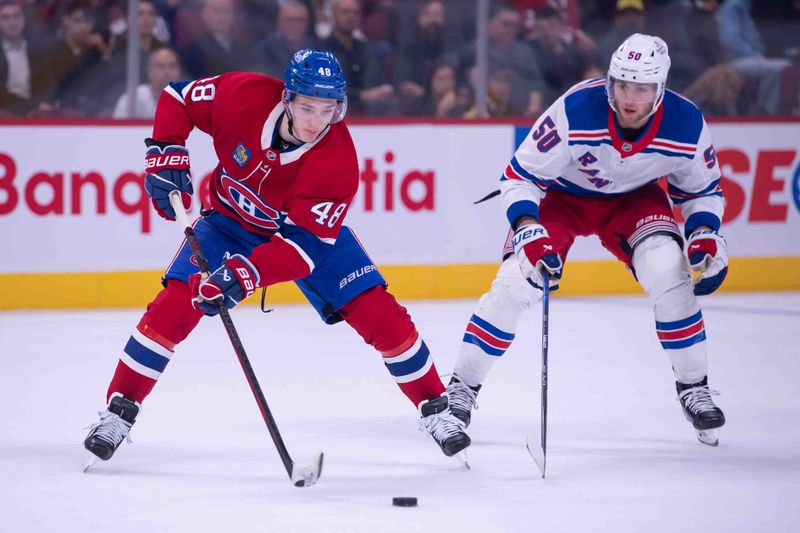 Oct 22, 2024; Ottawa, Ontario, CAN; Montreal Canadiens defenseman Lane Hutson (48) moves the puck away from New York Rangers left wing Will Cuylle (50) in the third period at the Bell Centre. Mandatory Credit: Marc DesRosiers-Imagn Images