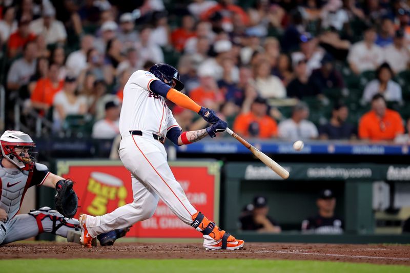 Jun 2, 2024; Houston, Texas, USA; Houston Astros catcher Victor Caratini (17) hits a home run to right field against the Minnesota Twins during the second inning during the second inning at Minute Maid Park. Mandatory Credit: Erik Williams-USA TODAY Sports