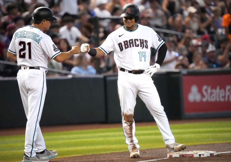 Jun 29, 2023; Phoenix, Arizona, USA; Arizona Diamondbacks catcher Gabriel Moreno (14) fist bumps third base coach Tony Perezchica (21) against the Tampa Bay Rays at Chase Field. Mandatory Credit: Joe Rondone-USA TODAY Sports