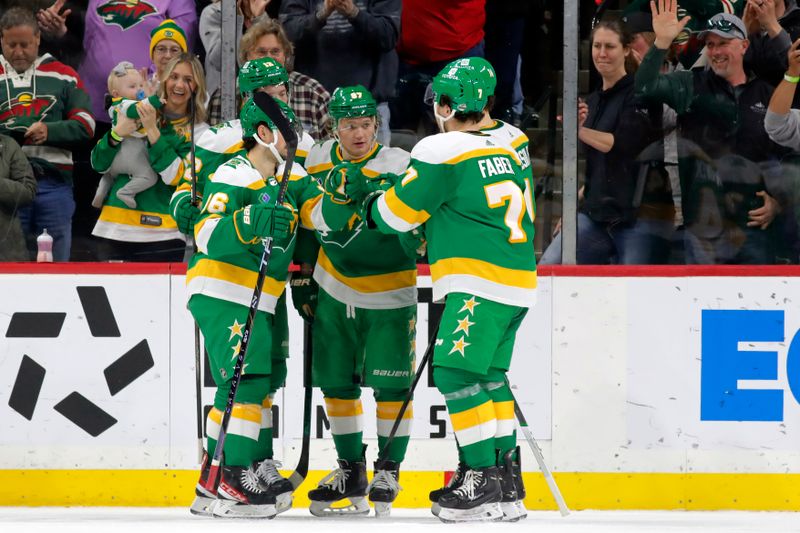 Apr 6, 2024; Saint Paul, Minnesota, USA;  Minnesota Wild left wing Kirill Kaprizov (97) celebrates with teammates after scoring a goal against the Winnipeg Jets during the first period at Xcel Energy Center. Mandatory Credit: Bruce Fedyck-USA TODAY Sports