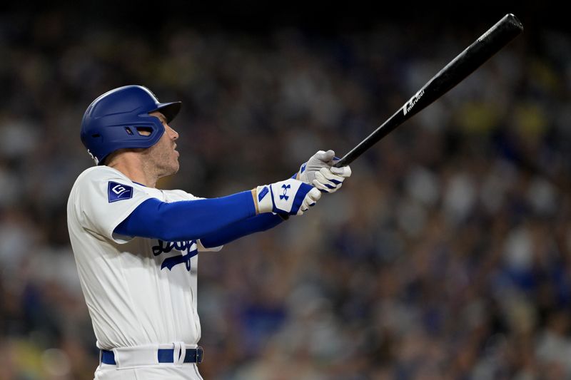 May 20, 2024; Los Angeles, California, USA;  Los Angeles Dodgers first baseman Freddie Freeman (5) hits a grand slam home run in the third inning against the Arizona Diamondbacks at Dodger Stadium. Mandatory Credit: Jayne Kamin-Oncea-USA TODAY Sports