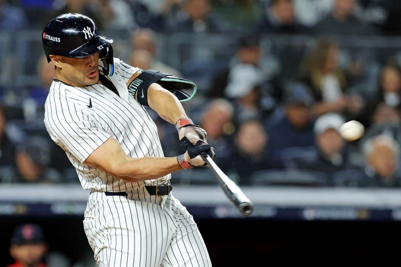 Oct 14, 2024; Bronx, New York, USA; New York Yankees designated hitter Giancarlo Stanton (27) hits a solo home run during the seventh inning against the Cleveland Guardians in game one of the ALCS for the 2024 MLB Playoffs at Yankee Stadium. Mandatory Credit: Brad Penner-Imagn Images