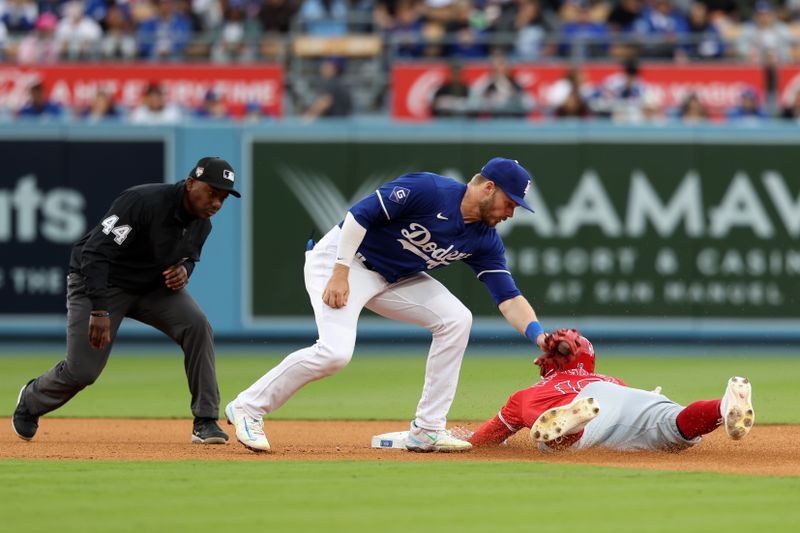 Mar 24, 2024; Los Angeles, California, USA;  Los Angeles Angels out fielder Jake Marisnick (10) is tagged out by Los Angeles Dodgers shortstop Gavin Lux (9) during the sixth inning at Dodger Stadium. Mandatory Credit: Kiyoshi Mio-USA TODAY Sports