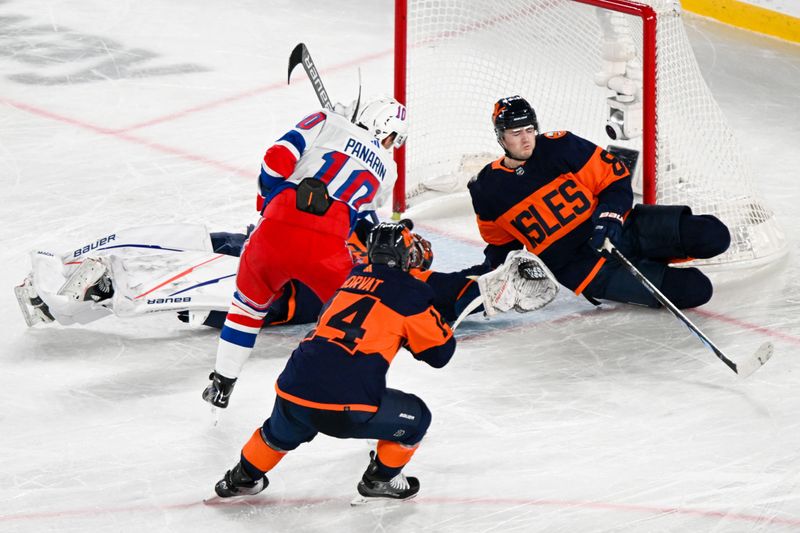 Feb 18, 2024; East Rutherford, New Jersey, USA;  New York Rangers left wing Artemi Panarin (10) scores the game winning goal against the New York Islanders during the overtime period in a Stadium Series ice hockey game at MetLife Stadium. Mandatory Credit: Dennis Schneidler-USA TODAY Sports