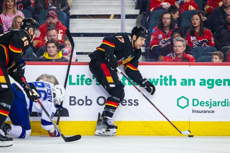 Jan 21, 2023; Calgary, Alberta, CAN; Calgary Flames left wing Milan Lucic (17) controls the puck against the Tampa Bay Lightning during the third period at Scotiabank Saddledome. Mandatory Credit: Sergei Belski-USA TODAY Sports