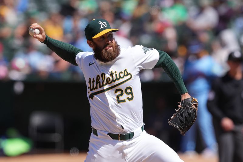 Jun 9, 2024; Oakland, California, USA; Oakland Athletics relief pitcher Austin Adams (29) throws a pitch against the Toronto Blue Jays during the tenth inning at Oakland-Alameda County Coliseum. Mandatory Credit: Darren Yamashita-USA TODAY Sports