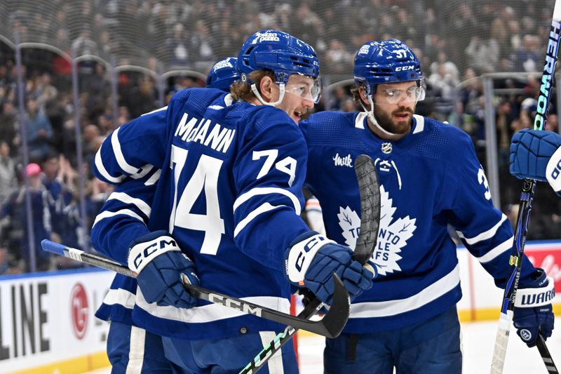 Mar 23, 2024; Toronto, Ontario, CAN; Toronto Maple Leafs forward Bobby McMann (74) celebrates with defenseman Timothy Liljegren (37) after scoring against the Edmonton Oilers in the first period at Scotiabank Arena. Mandatory Credit: Dan Hamilton-USA TODAY Sports