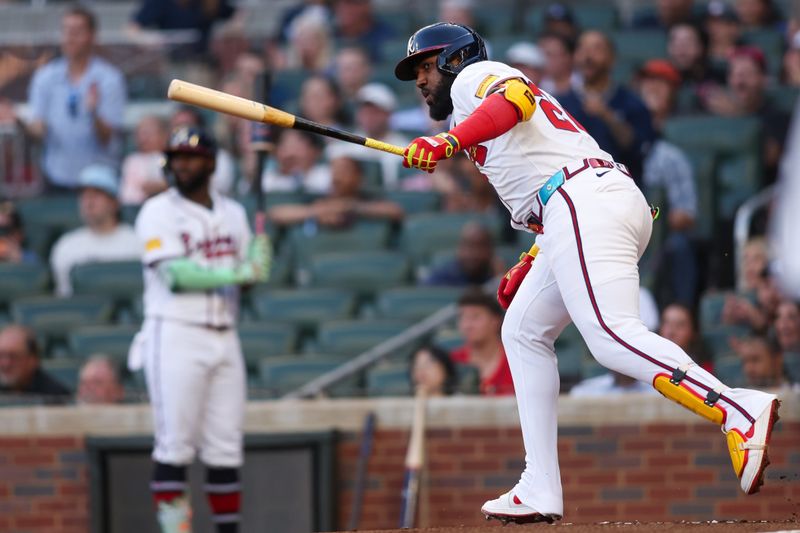 May 12, 2025; Atlanta, Georgia, USA; Atlanta Braves designated hitter Marcell Ozuna (20) hits an RBI single against the Washington Nationals in the third inning at Truist Park. Mandatory Credit: Brett Davis-Imagn Images
