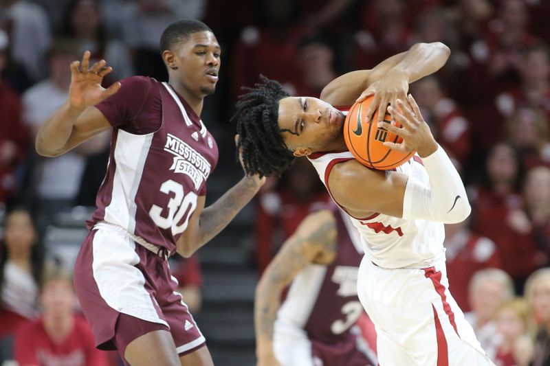 Feb 11, 2023; Fayetteville, Arkansas, USA; Arkansas Razorbacks guard Ricky Council IV (1) catches an inbound pass over his shoulder against Mississippi State Bulldogs guard Shawn Jones Jr (30) during the second half at Bud Walton Arena. The Bulldogs won 70-64. Mandatory Credit: Nelson Chenault-USA TODAY Sports