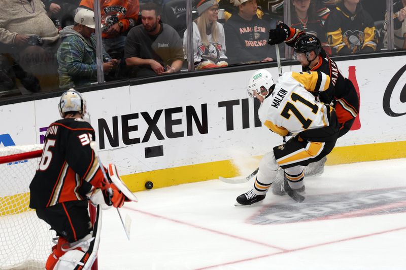 Nov 7, 2023; Anaheim, California, USA; Pittsburgh Penguins center Evgeni Malkin (71) and Anaheim Ducks defenseman Urho Vaakanainen (5) fights for the puck during the third period at Honda Center. Mandatory Credit: Kiyoshi Mio-USA TODAY Sports