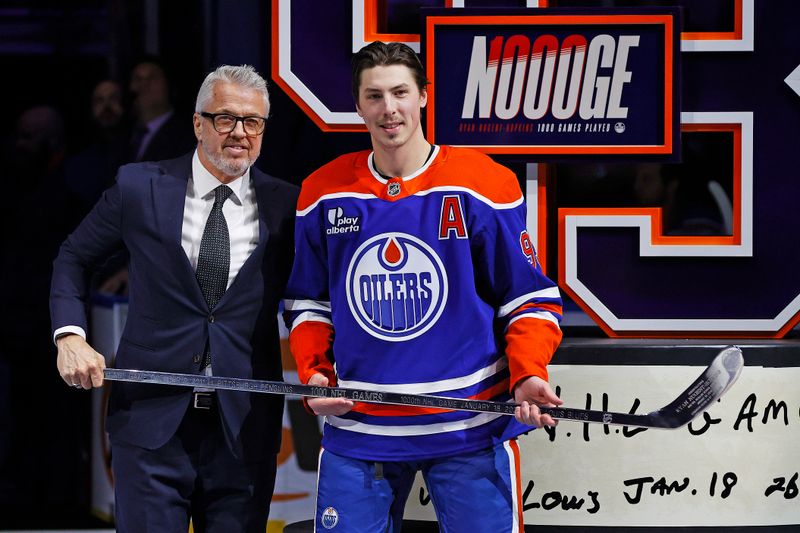 Jan 18, 2026; Edmonton, Alberta, CAN; Edmonton Oilers president Jeff Jackson presents Ryan Nugent-Hopkins (93) with a sliver stick celebrating his 1000th game as an Edmonton Oiler at Rogers Place. Mandatory Credit: Perry Nelson-Imagn Images
