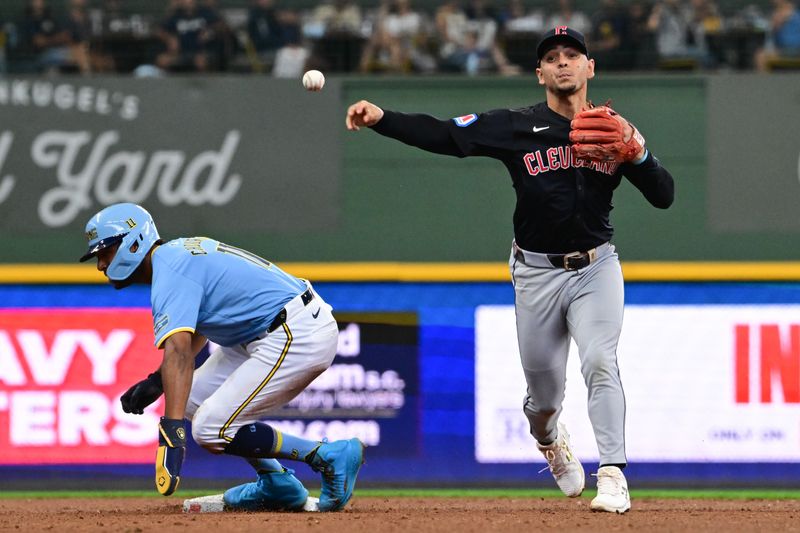 Aug 18, 2024; Milwaukee, Wisconsin, USA; Cleveland Guardians second baseman Andres Gimenez (0) completes a double play after forcing out Milwaukee Brewers left fielder Jackson Chourio (11) in the third inning at American Family Field. Mandatory Credit: Benny Sieu-USA TODAY Sports