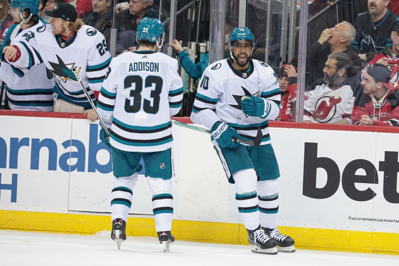 Dec 1, 2023; Newark, New Jersey, USA; San Jose Sharks left wing Anthony Duclair (10) celebrates his goal with defenseman Calen Addison (33) during the third period against the New Jersey Devils at Prudential Center. Mandatory Credit: Vincent Carchietta-USA TODAY Sports