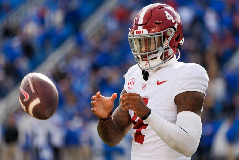 Nov 11, 2023; Lexington, Kentucky, USA; Alabama Crimson Tide quarterback Jalen Milroe (4) warms up during a timeout during the third quarter against the Kentucky Wildcats at Kroger Field. Mandatory Credit: Jordan Prather-USA TODAY Sports