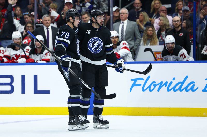 Nov 16, 2024; Tampa, Florida, USA; Tampa Bay Lightning defenseman Emil Lilleberg (78) congratulates left wing Nick Paul (20) after scoring a goal against the New Jersey Devils in the first period at Amalie Arena. Mandatory Credit: Nathan Ray Seebeck-Imagn Images