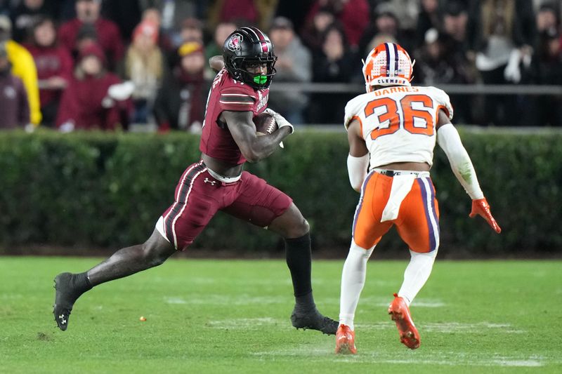 Nov 25, 2023; Columbia, South Carolina, USA; South Carolina Gamecocks wide receiver Xavier Legette (17) runs the ball against Clemson Tigers safety Khalil Barnes (36) at Williams-Brice Stadium. Mandatory Credit: David Yeazell-USA TODAY Sports