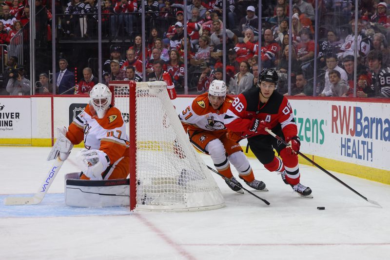 Oct 27, 2024; Newark, New Jersey, USA; New Jersey Devils center Jack Hughes (86) skates with the puck while being defended by Anaheim Ducks defenseman Olen Zellweger (51) during the second period at Prudential Center. Mandatory Credit: Ed Mulholland-Imagn Images