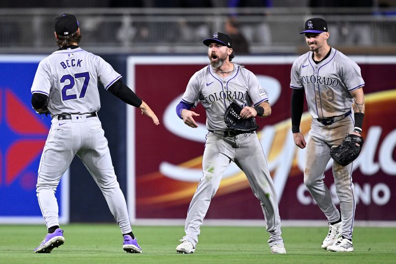 May 13, 2024; San Diego, California, USA; Colorado Rockies right fielder Jake Cave (11) celebrates on the field with left fielder Jordan Beck (27) and center fielder Brenton Doyle (9) after defeating the San Diego Padres at Petco Park. Mandatory Credit: Orlando Ramirez-USA TODAY Sports