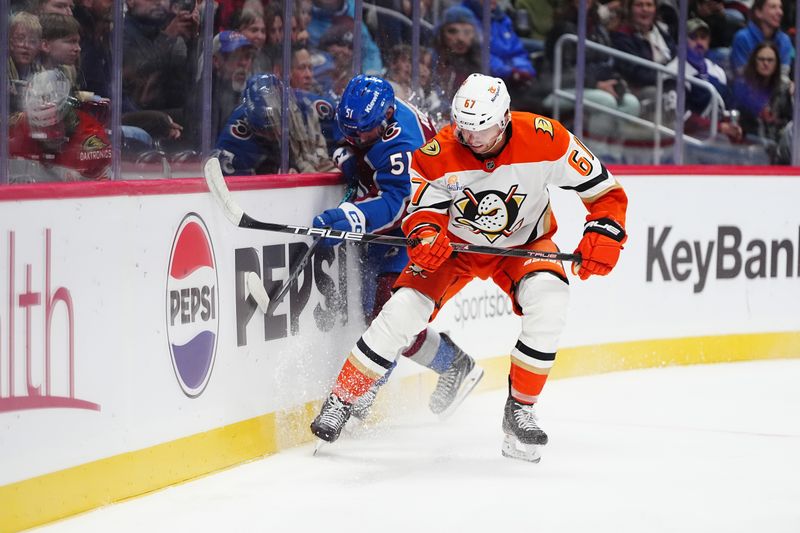 Oct 18, 2024; Denver, Colorado, USA; Anaheim Ducks defenseman Tristan Luneau (67) checks Colorado Avalanche right wing Nikolai Kovalenko (51) in the second period at Ball Arena. Mandatory Credit: Ron Chenoy-Imagn Images