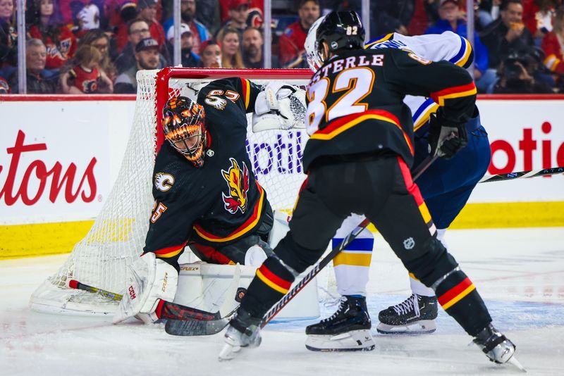 Jan 23, 2024; Calgary, Alberta, CAN; Calgary Flames goaltender Jacob Markstrom (25) makes a save against the St. Louis Blues during the first period at Scotiabank Saddledome. Mandatory Credit: Sergei Belski-USA TODAY Sports