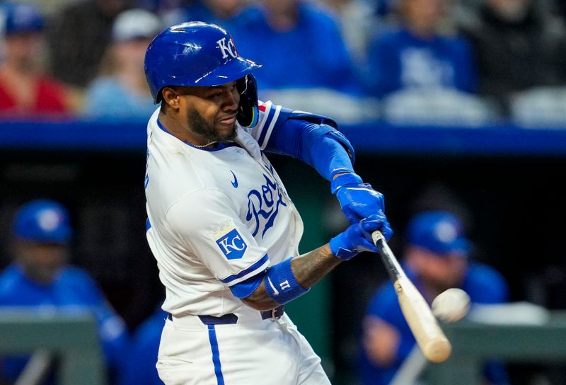 Apr 22, 2024; Kansas City, Missouri, USA; Kansas City Royals third base Maikel Garcia (11) hits a home run during the sixth inning against the Toronto Blue Jays at Kauffman Stadium. Mandatory Credit: Jay Biggerstaff-USA TODAY Sports