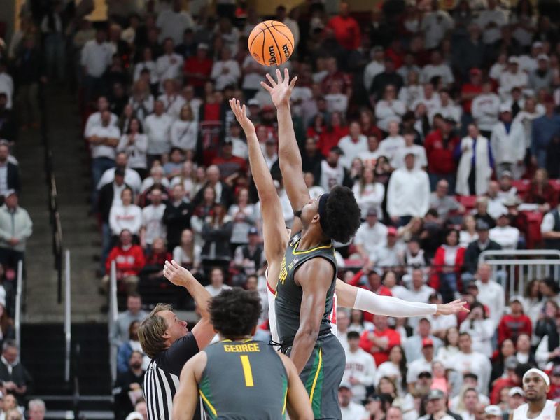 Jan 17, 2023; Lubbock, Texas, USA;  Baylor Bears forward Flo Thumb (0) and Texas Tech Red Raiders forward Fardaws Aimaq (11) vie for the opening tip at United Supermarkets Arena. Mandatory Credit: Michael C. Johnson-USA TODAY Sports